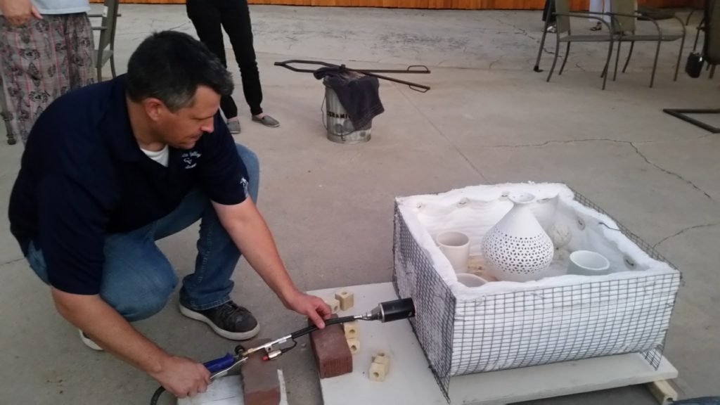 Mike Flower setting up kiln.